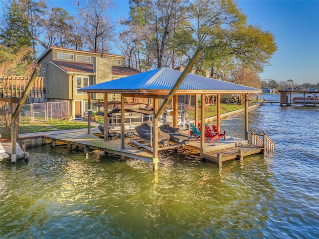 dock area with a water view and boat lift