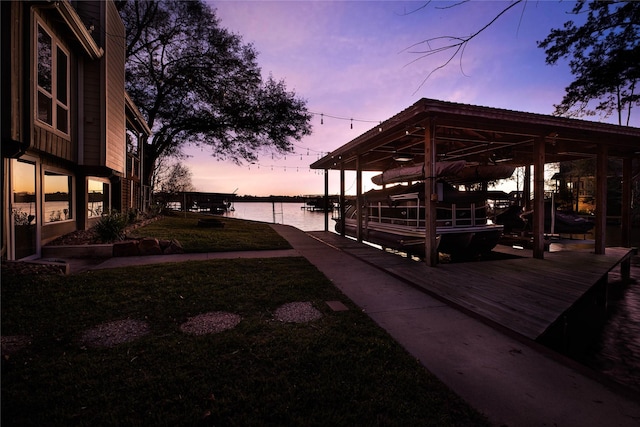 dock area featuring a water view and a yard