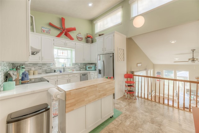 kitchen with sink, white cabinets, stainless steel appliances, and plenty of natural light