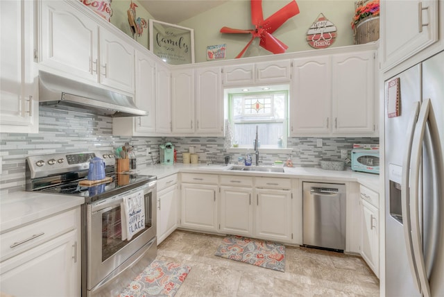 kitchen with decorative backsplash, sink, white cabinets, and appliances with stainless steel finishes