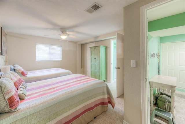 bedroom with ceiling fan and light carpet