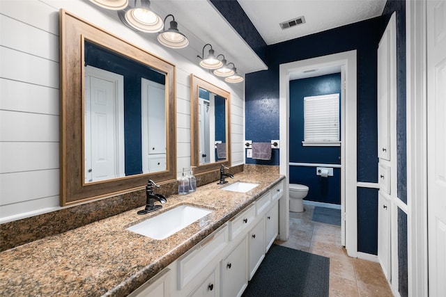 bathroom featuring toilet and vanity