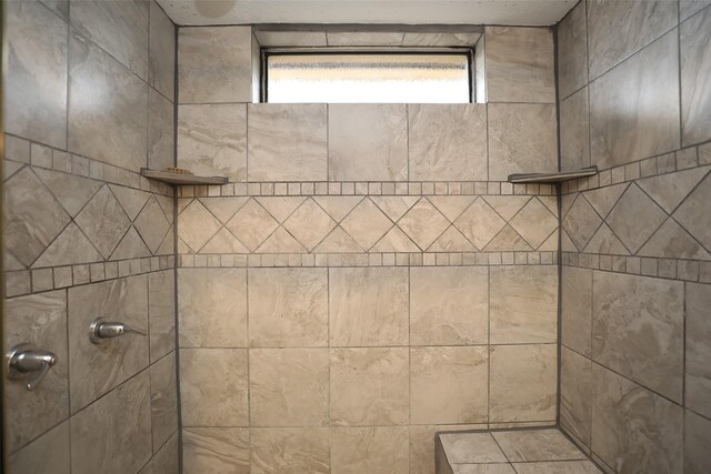 bathroom with tiled shower