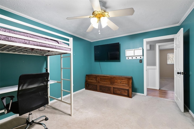 carpeted bedroom featuring ceiling fan and crown molding