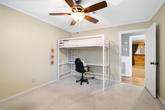 carpeted bedroom with crown molding and ceiling fan