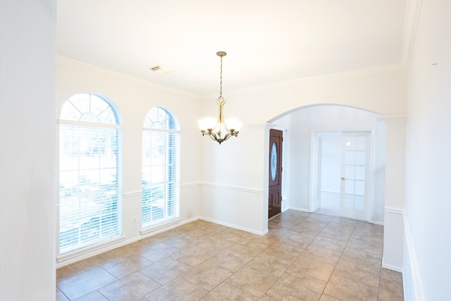 tiled empty room featuring a chandelier, french doors, and ornamental molding