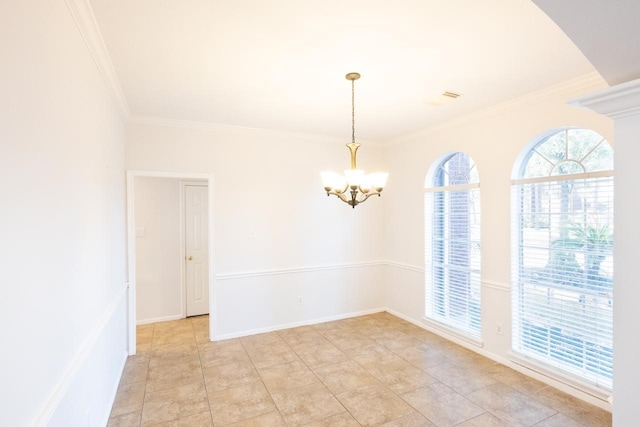 spare room featuring an inviting chandelier, ornamental molding, and light tile patterned flooring