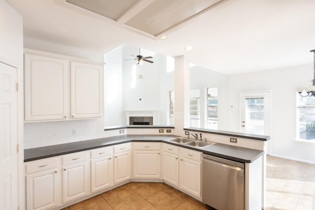 kitchen featuring backsplash, white cabinets, ceiling fan with notable chandelier, sink, and dishwasher