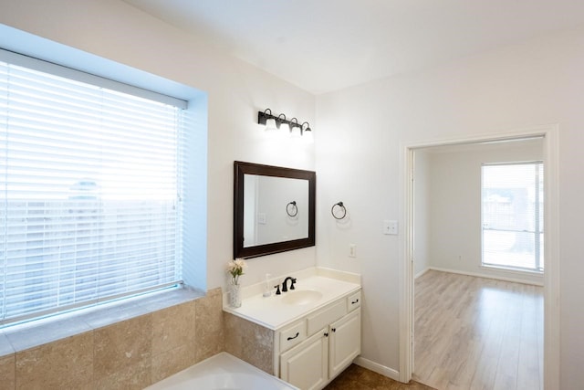 bathroom featuring vanity and a tub