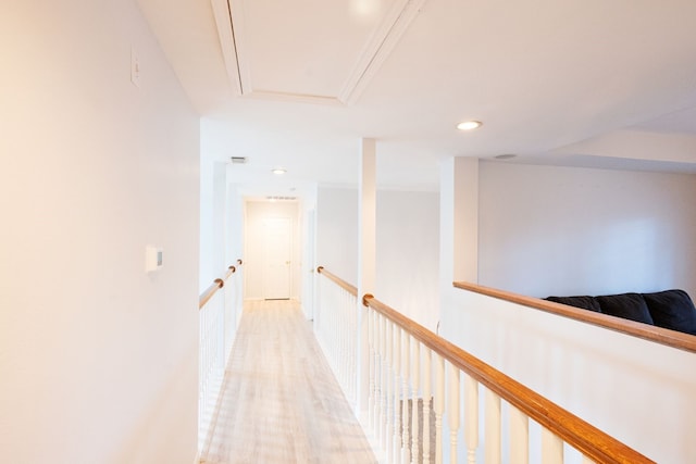 hall with light hardwood / wood-style flooring and ornamental molding