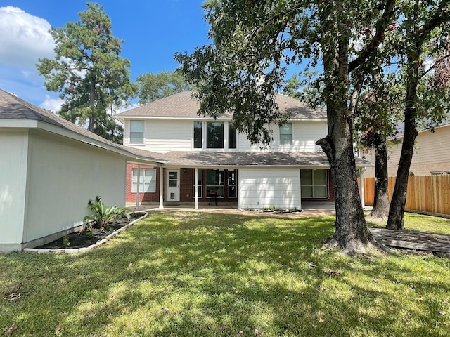 rear view of house featuring a patio area and a yard