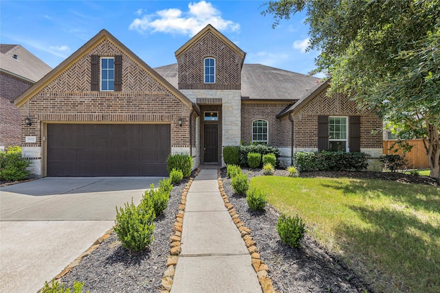 view of front of property with a garage and a front yard