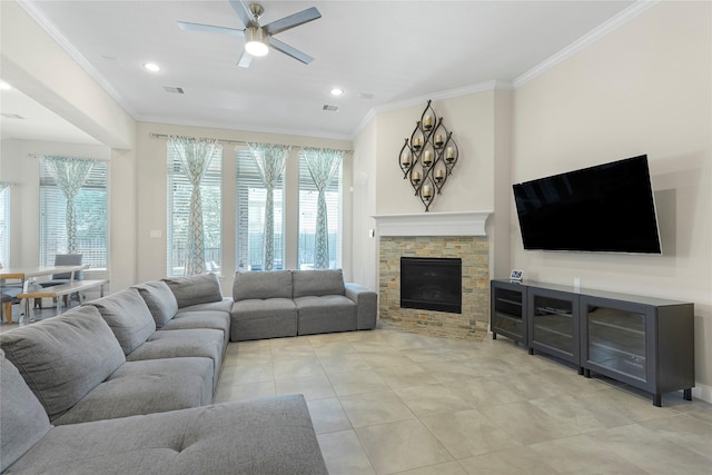 living room featuring a fireplace, ceiling fan, and crown molding