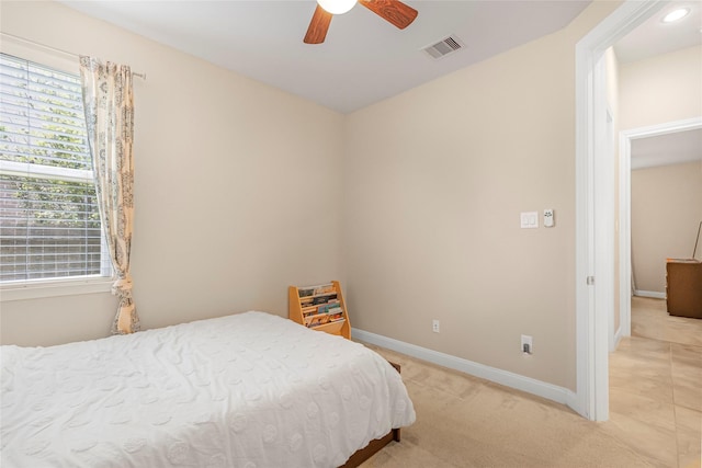 bedroom with light colored carpet and ceiling fan