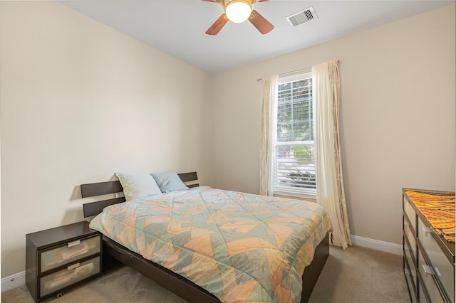 bedroom featuring light carpet and ceiling fan