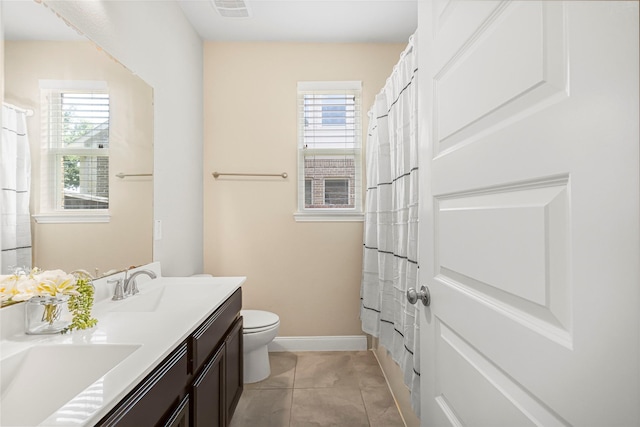 bathroom featuring tile patterned floors, vanity, and toilet