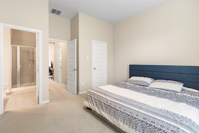 bedroom with ensuite bathroom and carpet