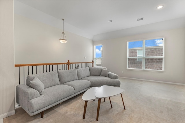 carpeted living room featuring lofted ceiling