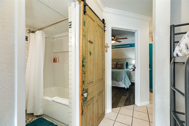 bathroom with crown molding, tile patterned flooring, ceiling fan, and shower / tub combo with curtain