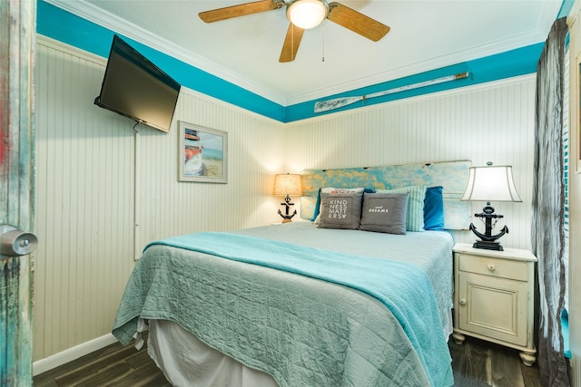 bedroom with dark hardwood / wood-style flooring, ceiling fan, and ornamental molding