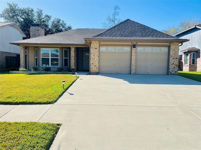 view of front of property featuring a garage and a front lawn