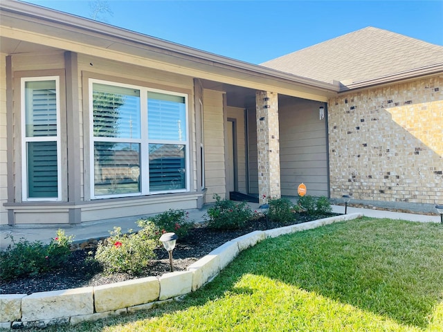 property entrance featuring a lawn