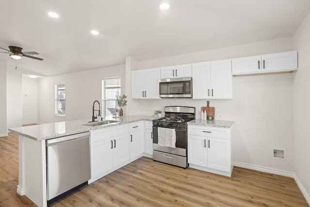 kitchen with white cabinetry, sink, and stainless steel appliances