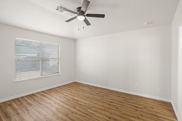 spare room with wood-type flooring and ceiling fan