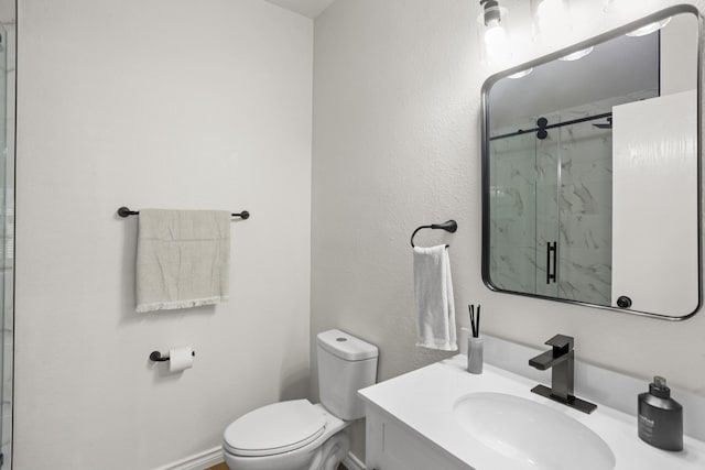 bathroom featuring vanity, an enclosed shower, and toilet