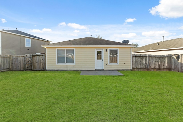 back of house with a yard and a patio area