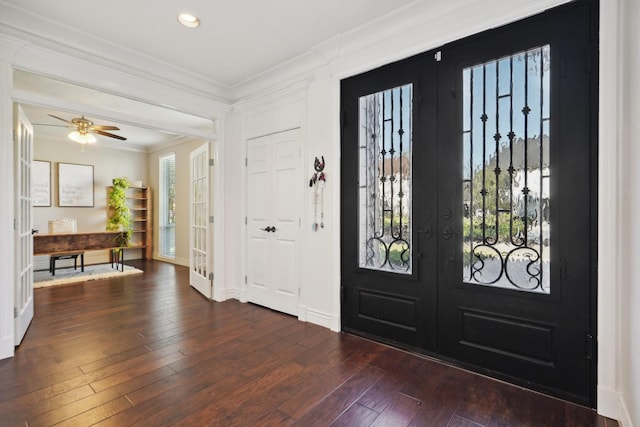 entryway with dark hardwood / wood-style floors, ceiling fan, crown molding, and french doors