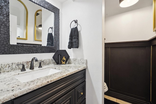 bathroom featuring vanity and toilet