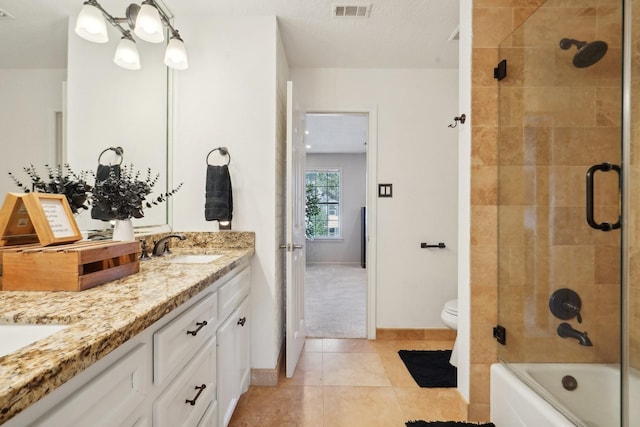 full bathroom featuring tile patterned flooring, vanity, toilet, and shower / bath combination with glass door