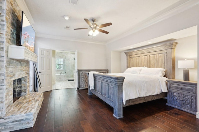 bedroom featuring dark hardwood / wood-style flooring, ensuite bathroom, ceiling fan, and ornamental molding