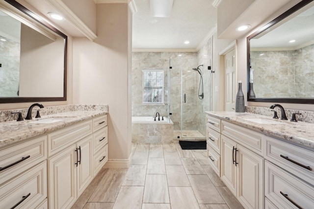 bathroom with plus walk in shower, vanity, and ornamental molding