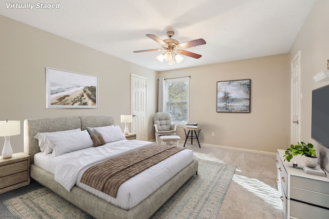 bedroom with ceiling fan and light colored carpet