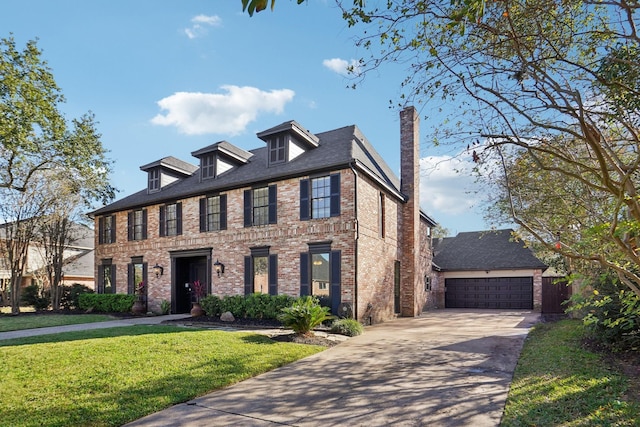 colonial home featuring a garage and a front lawn