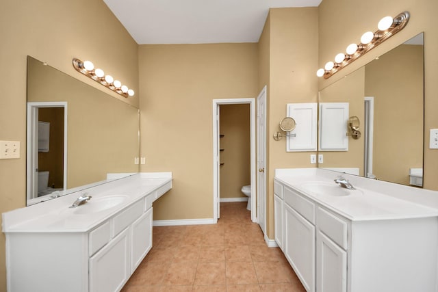 bathroom featuring tile patterned floors, vanity, and toilet