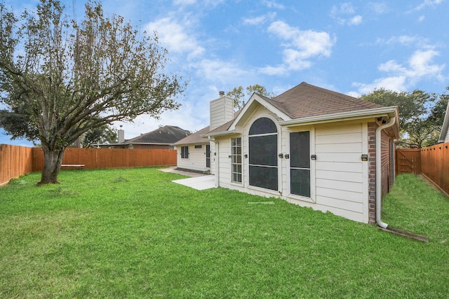 rear view of house with a lawn