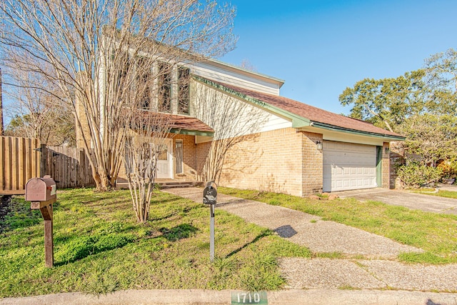 view of front of home with a front yard and a garage