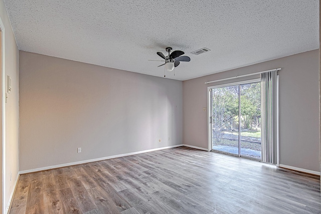 spare room featuring a textured ceiling, light hardwood / wood-style floors, and ceiling fan