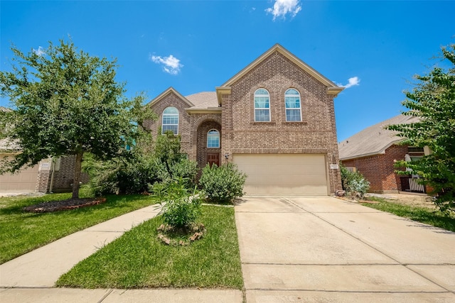 view of property with a front yard and a garage