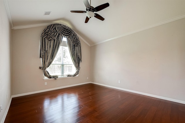 empty room with vaulted ceiling, ceiling fan, dark wood-type flooring, and crown molding