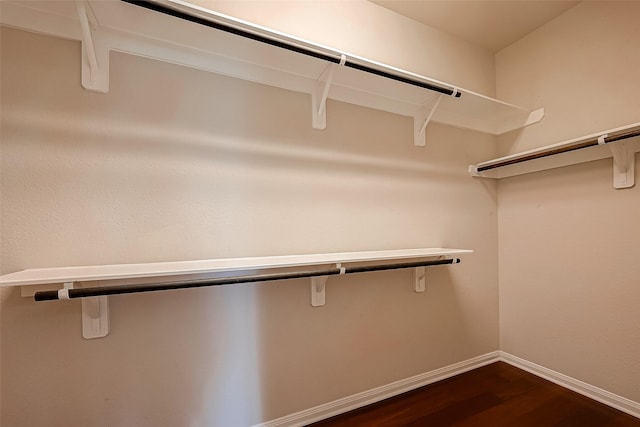 walk in closet featuring dark hardwood / wood-style floors