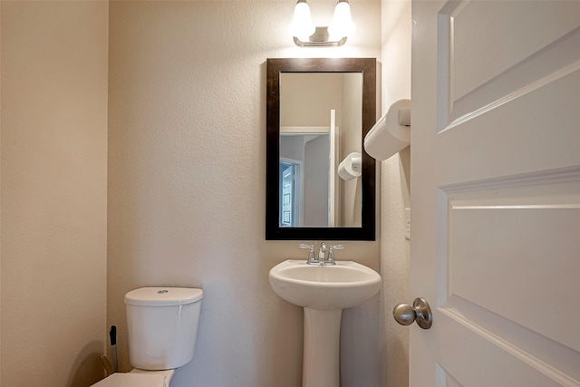 bathroom featuring sink and toilet