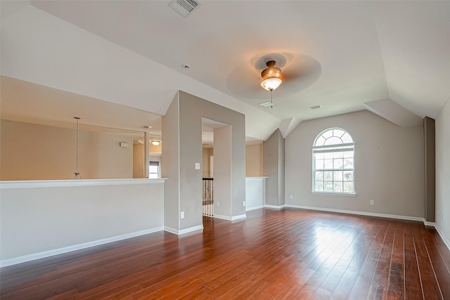 interior space with ceiling fan, lofted ceiling, and dark wood-type flooring