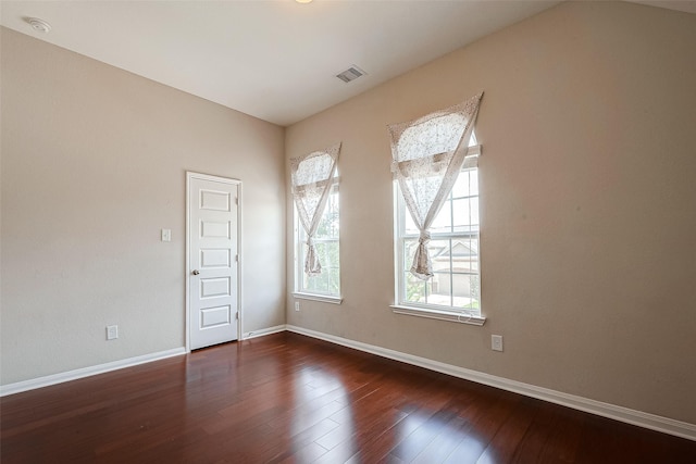 unfurnished room with dark hardwood / wood-style floors