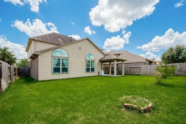 back of property featuring a lawn