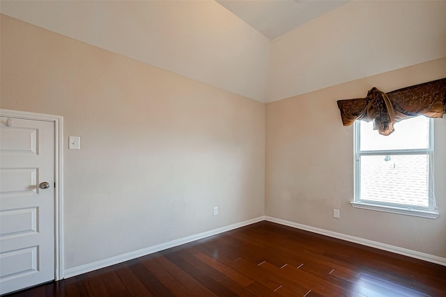 empty room featuring dark hardwood / wood-style flooring and vaulted ceiling