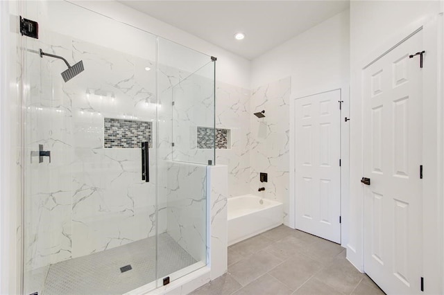 bathroom with tile patterned floors and independent shower and bath